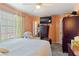 A bedroom featuring a TV, a wardrobe, a recliner chair, and carpet flooring at 12313 Citruswood Dr, Orlando, FL 32832