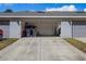Spacious two-car garage with ample room for storage, features modern gray doors, and an extra parking pad at 12313 Citruswood Dr, Orlando, FL 32832