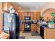 Functional kitchen with black appliances, wooden cabinetry, and ample counter space at 12313 Citruswood Dr, Orlando, FL 32832