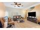 Open-concept living space with a staircase, tile floors, and comfortable seating at 12313 Citruswood Dr, Orlando, FL 32832