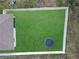 Aerial view of a lush green backyard with a white fence and trampoline in a private outdoor space at 1426 Powhatan Ct, Lakeland, FL 33805
