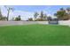 Fenced backyard with green lawn and a blue trampoline at 1426 Powhatan Ct, Lakeland, FL 33805