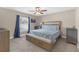 Primary bedroom with ceiling fan and a window offers a serene retreat with soft, natural light at 1426 Powhatan Ct, Lakeland, FL 33805