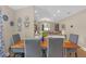 Open concept dining room with wood flooring with seating for four and decorative plates on the wall at 1426 Powhatan Ct, Lakeland, FL 33805
