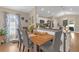Open concept dining room with wood flooring with seating for four and decorative plates on the wall at 1426 Powhatan Ct, Lakeland, FL 33805