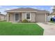 Charming single-story home with a well-maintained lawn, a blue door, and a one car garage at 1426 Powhatan Ct, Lakeland, FL 33805