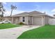 View of a single-story home featuring a well-manicured lawn, driveway, and a one car garage at 1426 Powhatan Ct, Lakeland, FL 33805