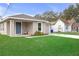 Charming home featuring a well-manicured front lawn and inviting entrance at 1426 Powhatan Ct, Lakeland, FL 33805