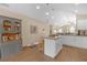 Bright kitchen features an island, white cabinetry, and a stylish hutch for convenient storage and display at 1426 Powhatan Ct, Lakeland, FL 33805