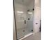 Modern bathroom featuring glass shower door and black hardware with tiled walls and floors at 1630 Haven Dr, Orlando, FL 32803