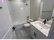 Well-lit bathroom with white fixtures, modern vanity, and a shower-tub combo at 1630 Haven Dr, Orlando, FL 32803