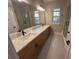 Bathroom featuring a double vanity and walk-in shower at 1630 Haven Dr, Orlando, FL 32803