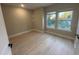 Bright bedroom featuring wood floors, neutral walls, and view outside the double windows at 1630 Haven Dr, Orlando, FL 32803