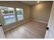 Bright bedroom featuring wood floors, neutral walls, and view outside the double windows at 1630 Haven Dr, Orlando, FL 32803