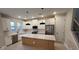 Modern kitchen featuring white cabinetry, stainless steel appliances, and a center island at 1630 Haven Dr, Orlando, FL 32803