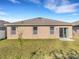 Exterior view of home with a patio and a grass backyard at 3214 Bayou Bay Dr, Lakeland, FL 33811