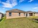 Exterior view of home with a patio and a large grassy backyard at 3214 Bayou Bay Dr, Lakeland, FL 33811