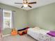 Bright bedroom with carpet, ceiling fan, and a window letting in natural light at 3214 Bayou Bay Dr, Lakeland, FL 33811