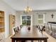 Bright dining area with a large wooden table, chandelier, and sliding glass doors leading to the backyard at 3214 Bayou Bay Dr, Lakeland, FL 33811