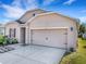 Traditional-style home with a two-car garage and well-maintained landscaping at 3214 Bayou Bay Dr, Lakeland, FL 33811