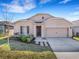 Charming single-story home featuring a well-maintained lawn and inviting front entrance and attached two car garage at 3214 Bayou Bay Dr, Lakeland, FL 33811