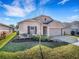 Well-maintained, one-story home with a tidy lawn, tasteful landscaping, and a welcoming facade at 3214 Bayou Bay Dr, Lakeland, FL 33811