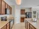 Well-lit kitchen with stainless steel appliances, wood cabinets, tile flooring, and ample counter space at 3214 Bayou Bay Dr, Lakeland, FL 33811