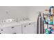Functional laundry room with a Maytag washer and dryer and storage shelving at 3214 Bayou Bay Dr, Lakeland, FL 33811