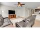 Inviting living room with wood-look flooring, a flat-screen TV, comfortable leather seating, and neutral paint colors at 3214 Bayou Bay Dr, Lakeland, FL 33811
