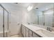 Elegant bathroom with double vanity, large mirror, and glass-enclosed shower with tile surround at 5421 Sw 82Nd Ter, Ocala, FL 34481