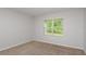 Cozy bedroom featuring neutral carpet, light gray walls and a bright window at 5421 Sw 82Nd Ter, Ocala, FL 34481