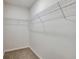 Walk-in closet with ample shelving and neutral carpet, offering generous storage space at 5421 Sw 82Nd Ter, Ocala, FL 34481