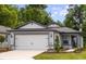 Charming single-story home with a two-car garage and beautifully landscaped front yard at 5421 Sw 82Nd Ter, Ocala, FL 34481