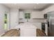 Bright kitchen with white cabinets, stainless steel appliances, island, and view to backyard at 5421 Sw 82Nd Ter, Ocala, FL 34481