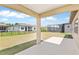 A large backyard view from a patio, featuring a lawn, iron fence, and a screened in pool at 9009 Sw 52Nd Place Rd, Ocala, FL 34481