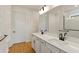 Bright bathroom with double sink vanity, quartz counters, and a large mirror at 9009 Sw 52Nd Place Rd, Ocala, FL 34481