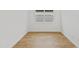 Empty bedroom showcasing light-filled space with wood floors, and a window at 9009 Sw 52Nd Place Rd, Ocala, FL 34481