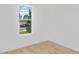 Bedroom showing bright window view of tree lined street and wood floors at 9009 Sw 52Nd Place Rd, Ocala, FL 34481
