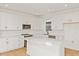 Bright kitchen with stainless steel appliances, tile backsplash, quartz counters, and a kitchen island at 9009 Sw 52Nd Place Rd, Ocala, FL 34481