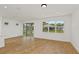 Bright living room featuring neutral walls, tiled flooring, recessed lighting, and a sliding glass door at 9009 Sw 52Nd Place Rd, Ocala, FL 34481
