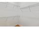 A well organized walk-in closet with metal shelving and wood flooring at 9009 Sw 52Nd Place Rd, Ocala, FL 34481
