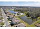 Community aerial view featuring residences, ponds, community pool, and green spaces at 4323 Trotters Way, Lakeland, FL 33801