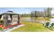 Backyard showcasing a gazebo overlooking a pond, offering a peaceful outdoor retreat at 4323 Trotters Way, Lakeland, FL 33801