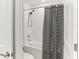 Clean bathroom featuring a shower-tub combination with tiled walls at 4323 Trotters Way, Lakeland, FL 33801