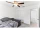 Cozy bedroom features a ceiling fan, a grey sofa bed, and a closet for ample storage at 4323 Trotters Way, Lakeland, FL 33801