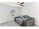 Comfortable bedroom featuring neutral colors, natural light, and simple furnishings at 4323 Trotters Way, Lakeland, FL 33801