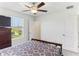 Bedroom features a window with outdoor view, plus ceiling fan and two doors at 4323 Trotters Way, Lakeland, FL 33801