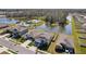 Aerial view of two-story home with community pool in the background and beautiful water view at 4323 Trotters Way, Lakeland, FL 33801