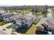Exterior view of two-story home with neutral tones, well-kept lawn, and view of community pool at 4323 Trotters Way, Lakeland, FL 33801