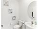 Bright half bath features round mirror, toilet, sink, and wall decor at 4323 Trotters Way, Lakeland, FL 33801